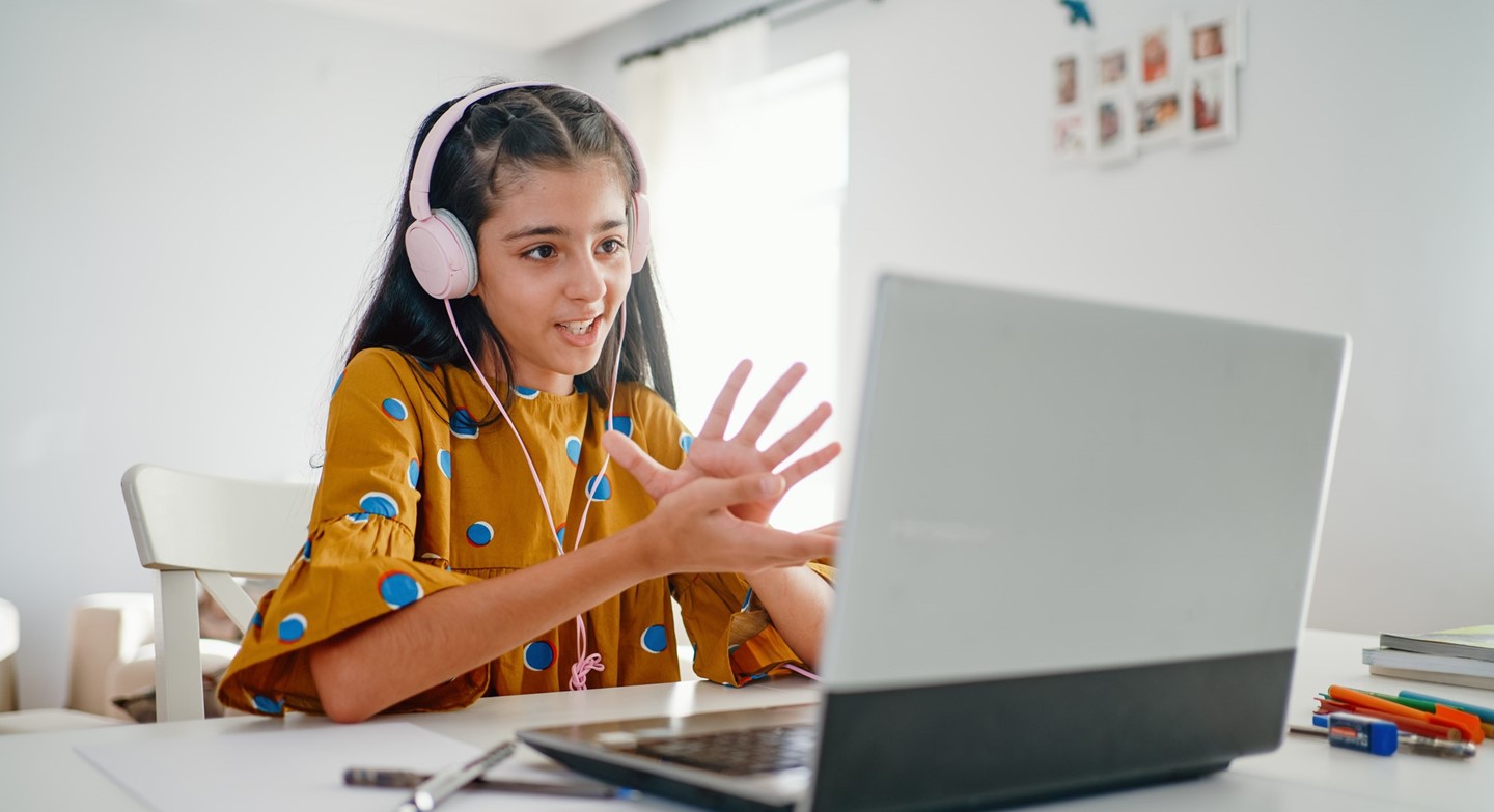 Girl with headphones on laptop