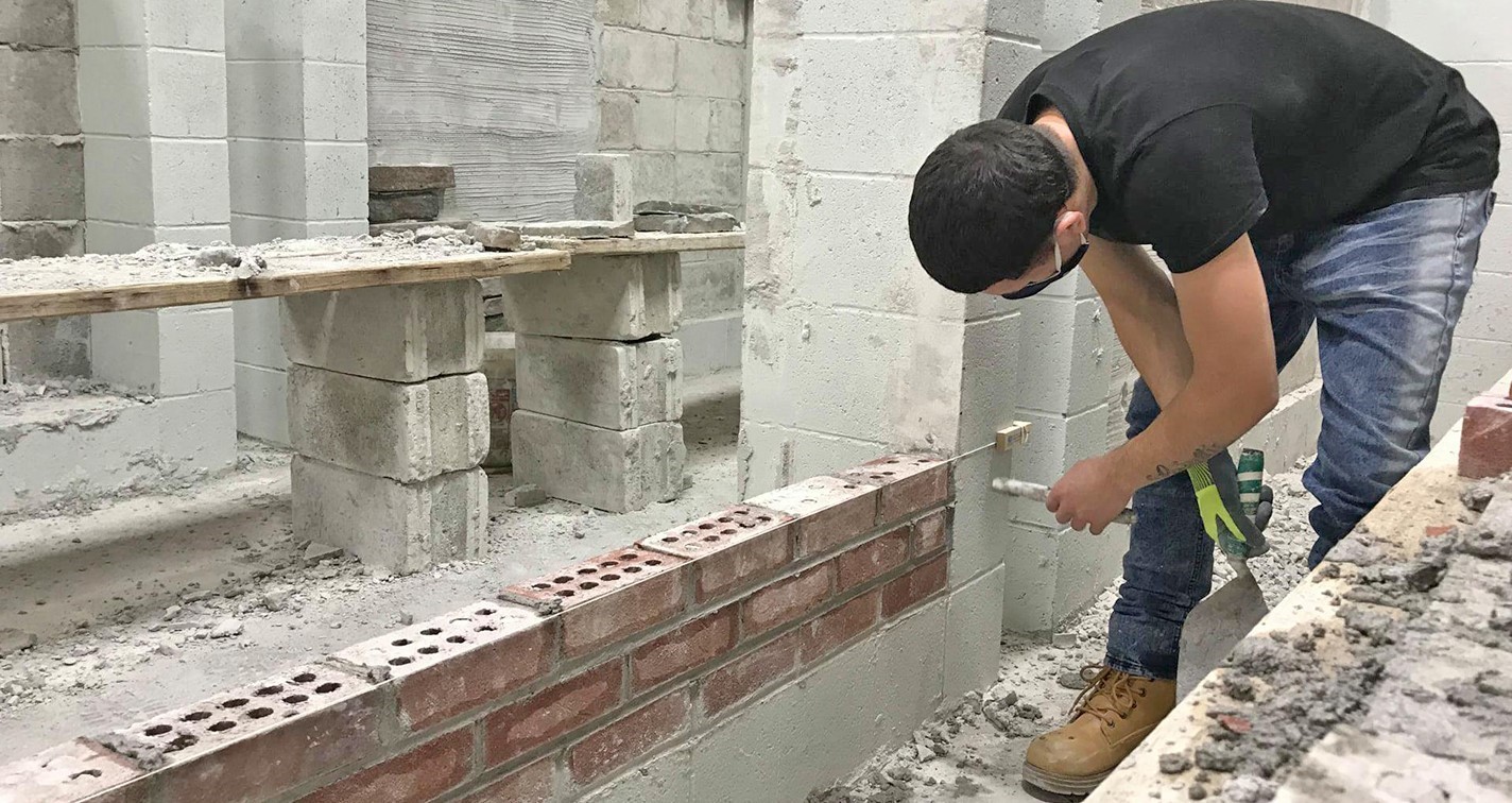 Student building brick wall